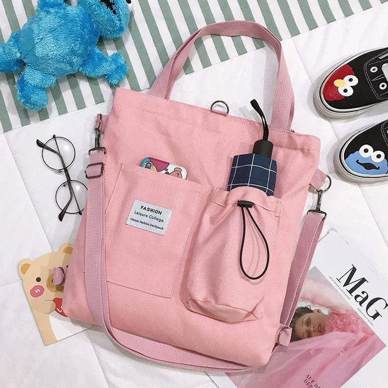 Harajuku pink canvas handbag with pockets and shoulder strap, perfect for students and casual outings.