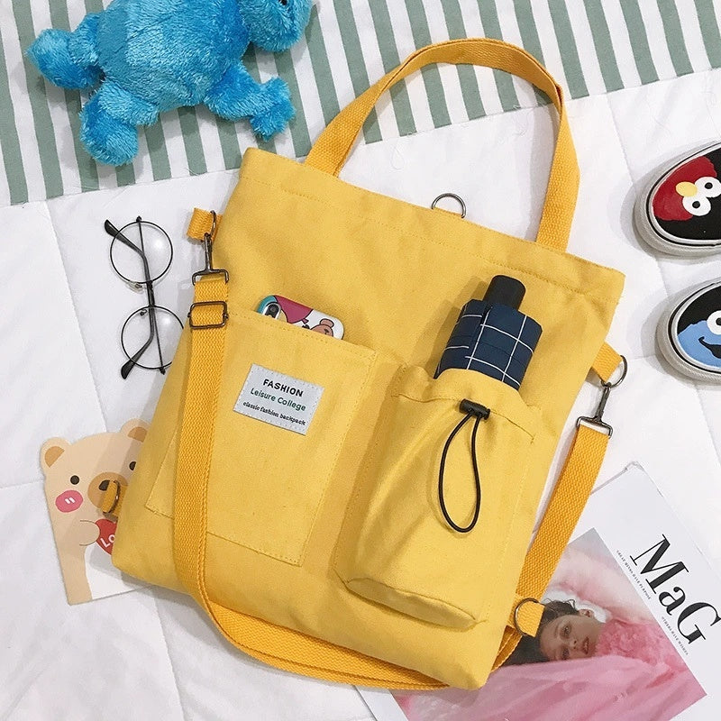 Yellow Harajuku canvas handbag with pockets and shoulder strap, perfect for students and casual outings.