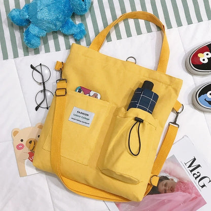 Yellow Harajuku canvas handbag with pockets and shoulder strap, perfect for students and casual outings.